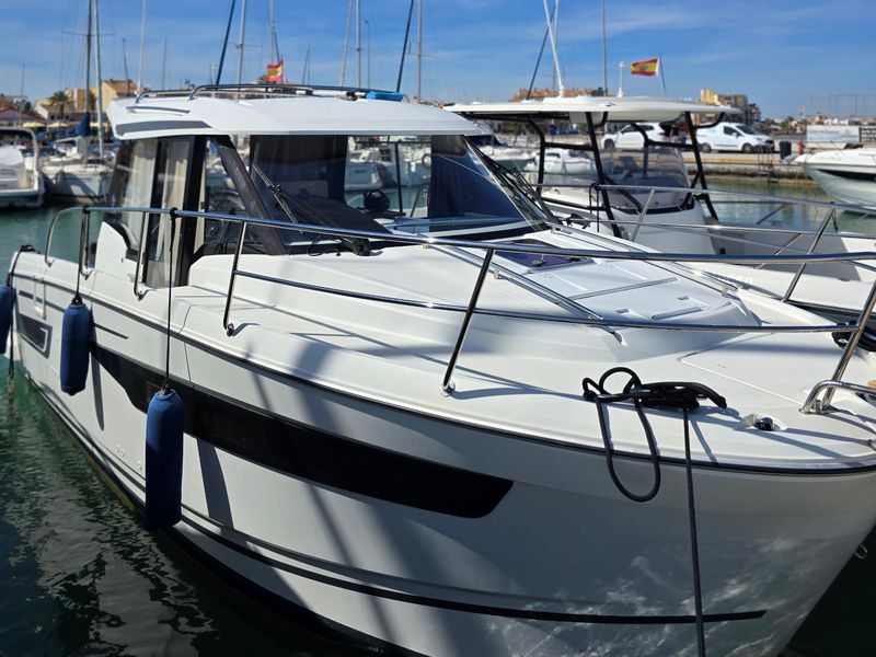 A freshly cleaned white motor boat at its berth in a Mar Menor marina