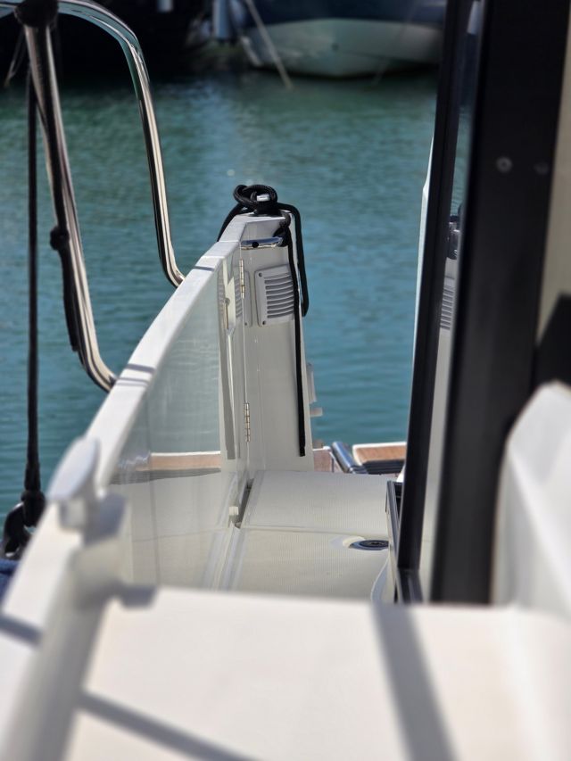 Clean white gelcoat and walkway at the stern of a motor boat