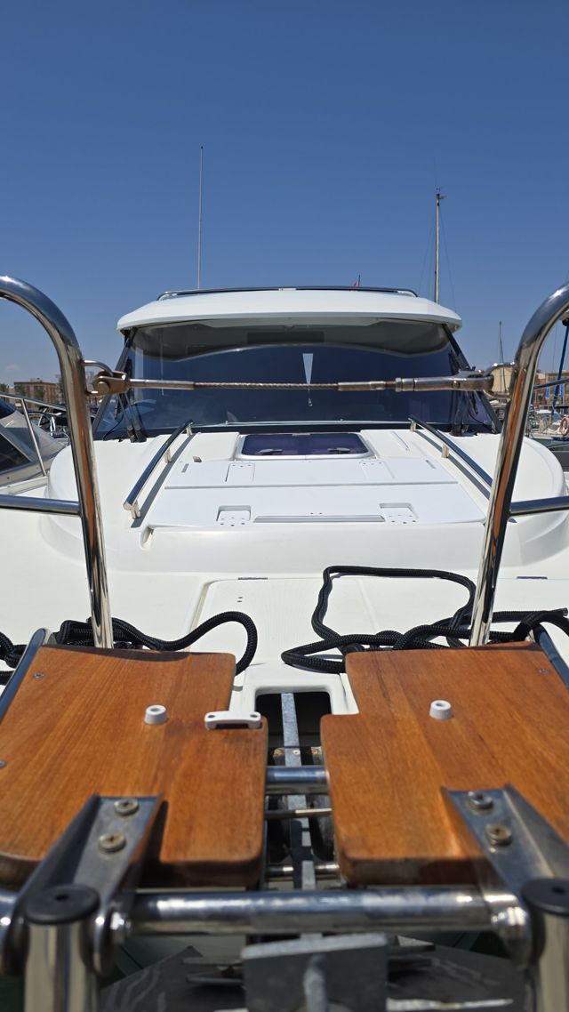 View along the bow of a freshly cleaned motor boat at its berth