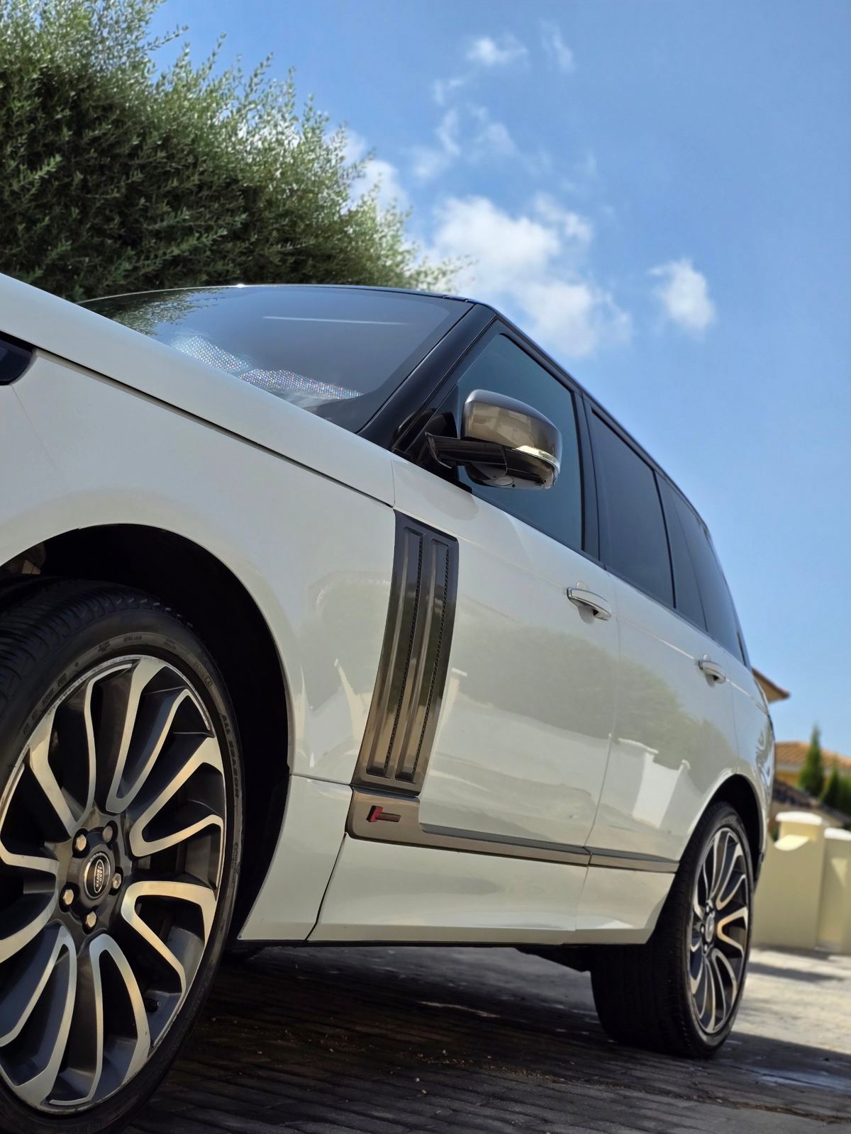 A white Range Rover with polished wheels after a mobile valet